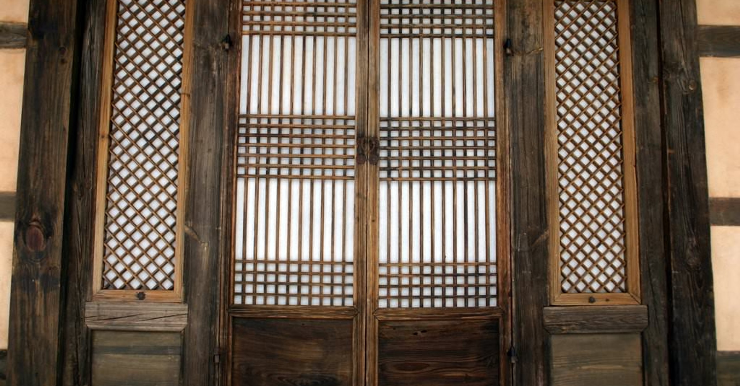 Traditional Korean hanok door and lattice windows covered with handmade hanji paper in snowy Andong, Gyeongsangbuk-do, showing how mulberry paper glows when backlit