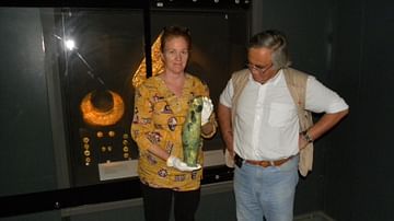 Professor Theodore Antikas with Laura-Wynn Antikas Holding the Shorter Greave from the Royal Tomb of Vergina