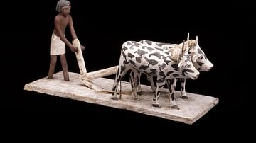 Wooden model of a man ploughing with oxen