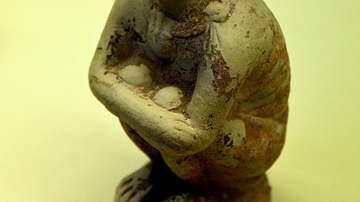 Flask Showing a Crouching African