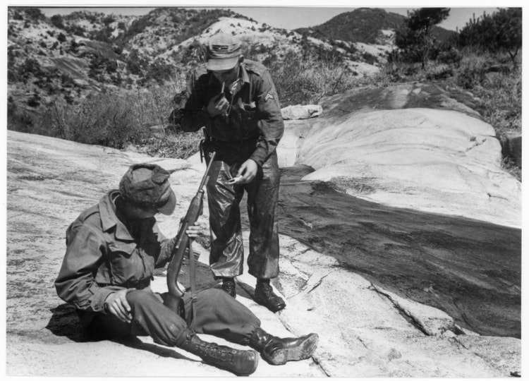 Two United Nations Soldiers Take a Smoke Break