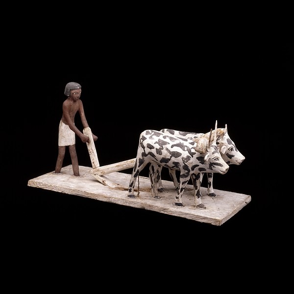 Wooden model of a man ploughing with oxen