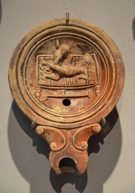 Roman oil lamp with erotic scene