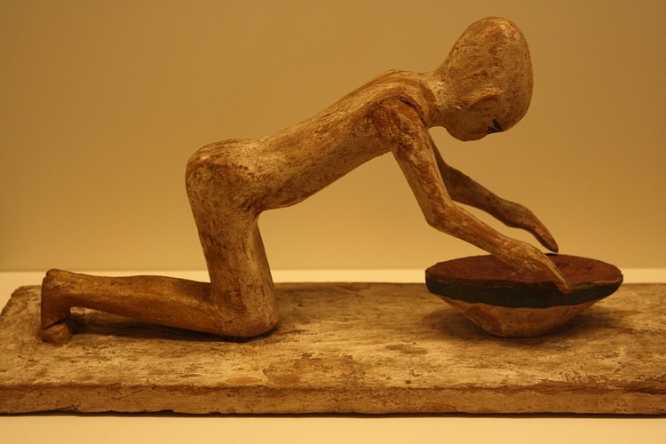 Egyptian Wooden Statue of a Woman Grinding Cereals