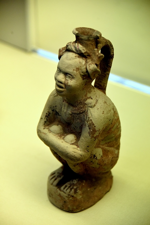 Flask Showing a Crouching African
